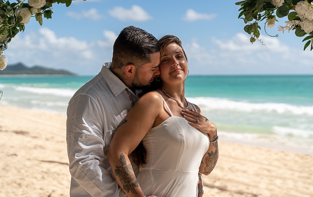 Ryan Sakamoto is a Honolulu elopement photographer on Oahu. Aubrey & Becca pose for their elopement photographs at Sherwood Beach on Oahu.