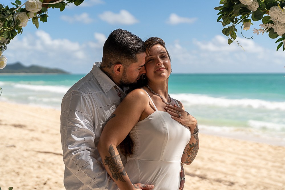 Ryan Sakamoto is a Honolulu elopement photographer on Oahu. Aubrey & Becca pose for their elopement photographs at Sherwood Beach on Oahu.